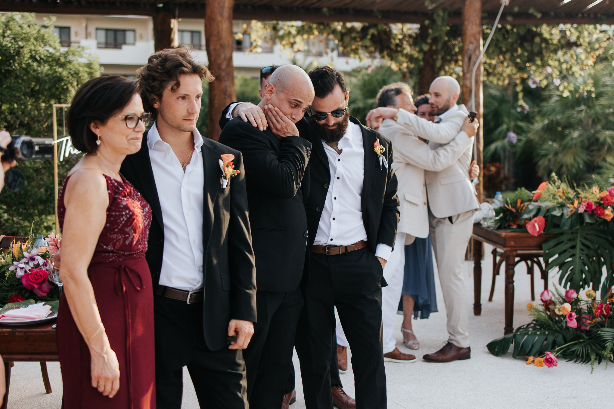 Groom embraced by groomsmen